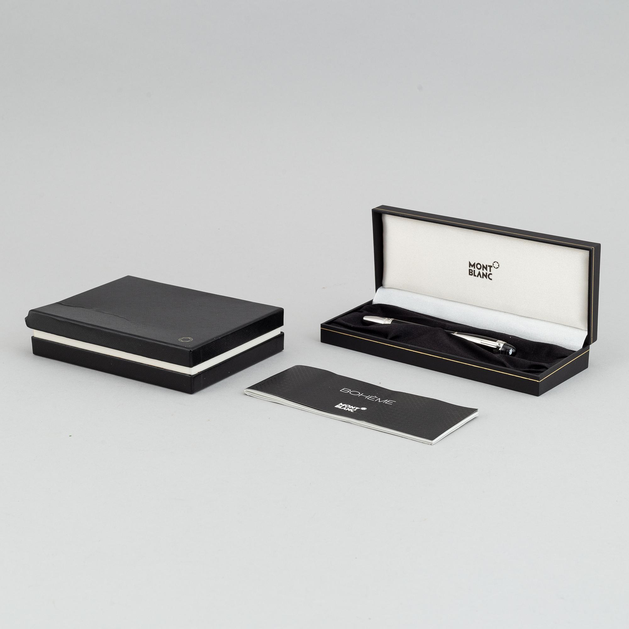 MOntblanc, a ball point pen and leather passport holder.