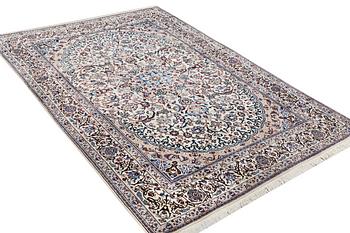 A Nain carpet, part silk, 9 laa, ca. 318 x 209 cm.