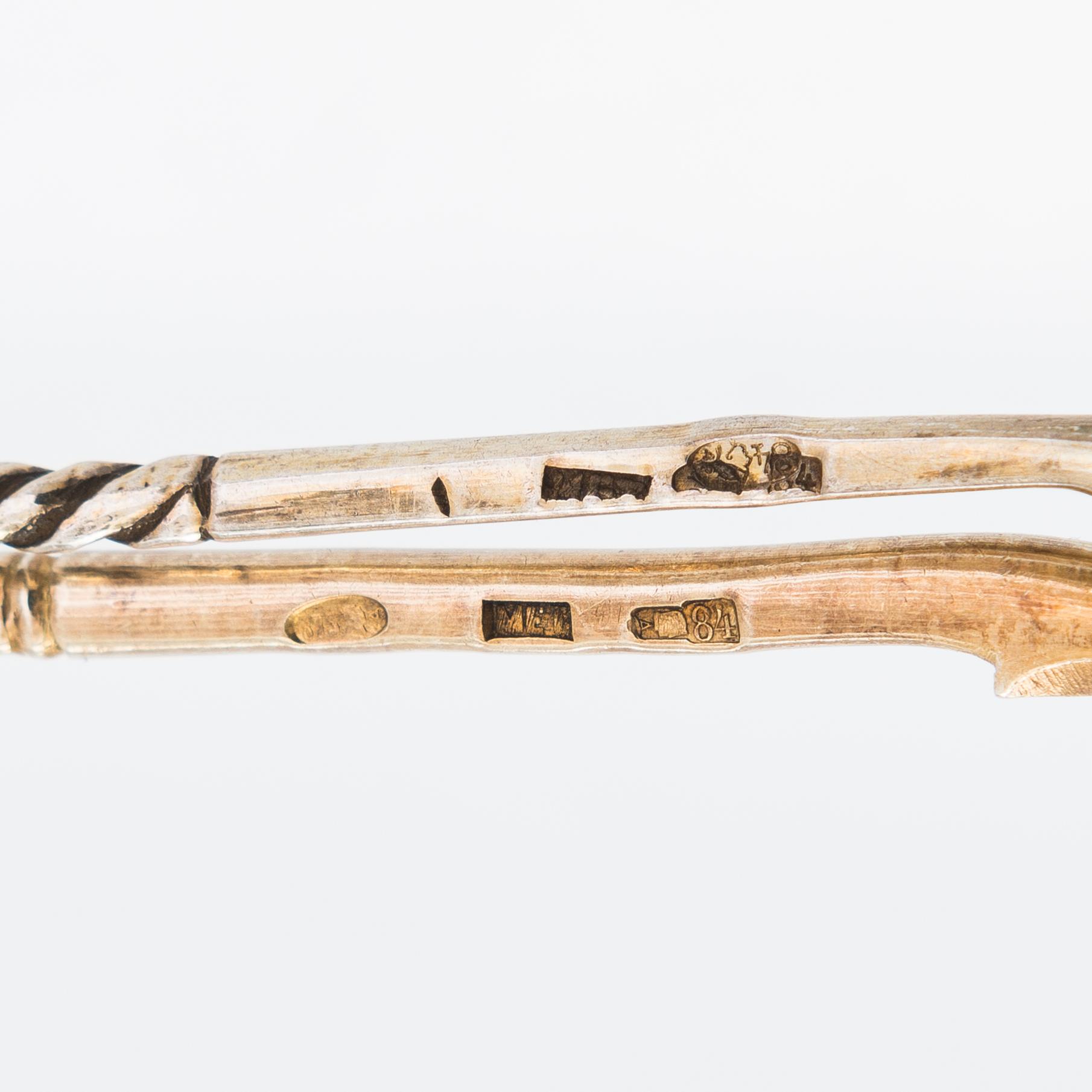 Twelve parcel-gilt teaspoons and a jam spoon, Russia 1887-1926.