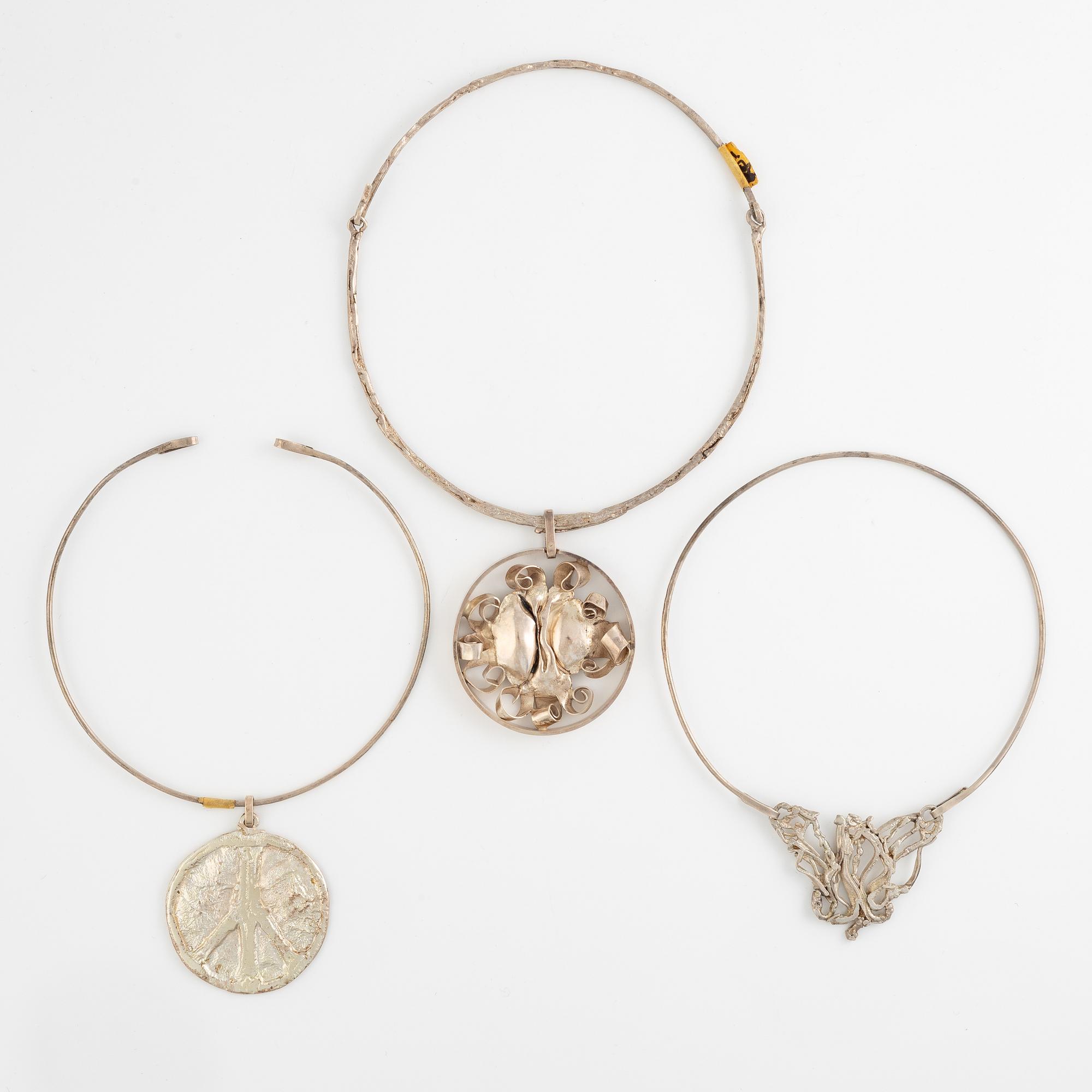 Lars Arby, three neck rings with pendants, silver, Gothenburg including 1977, 1978, and 1982.