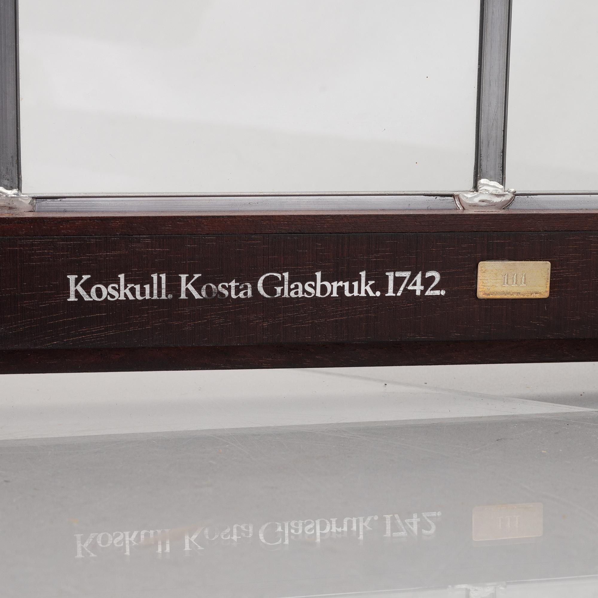A display cabinet with a 47-piece glass service, "Koskull" from Kosta, Sweden.