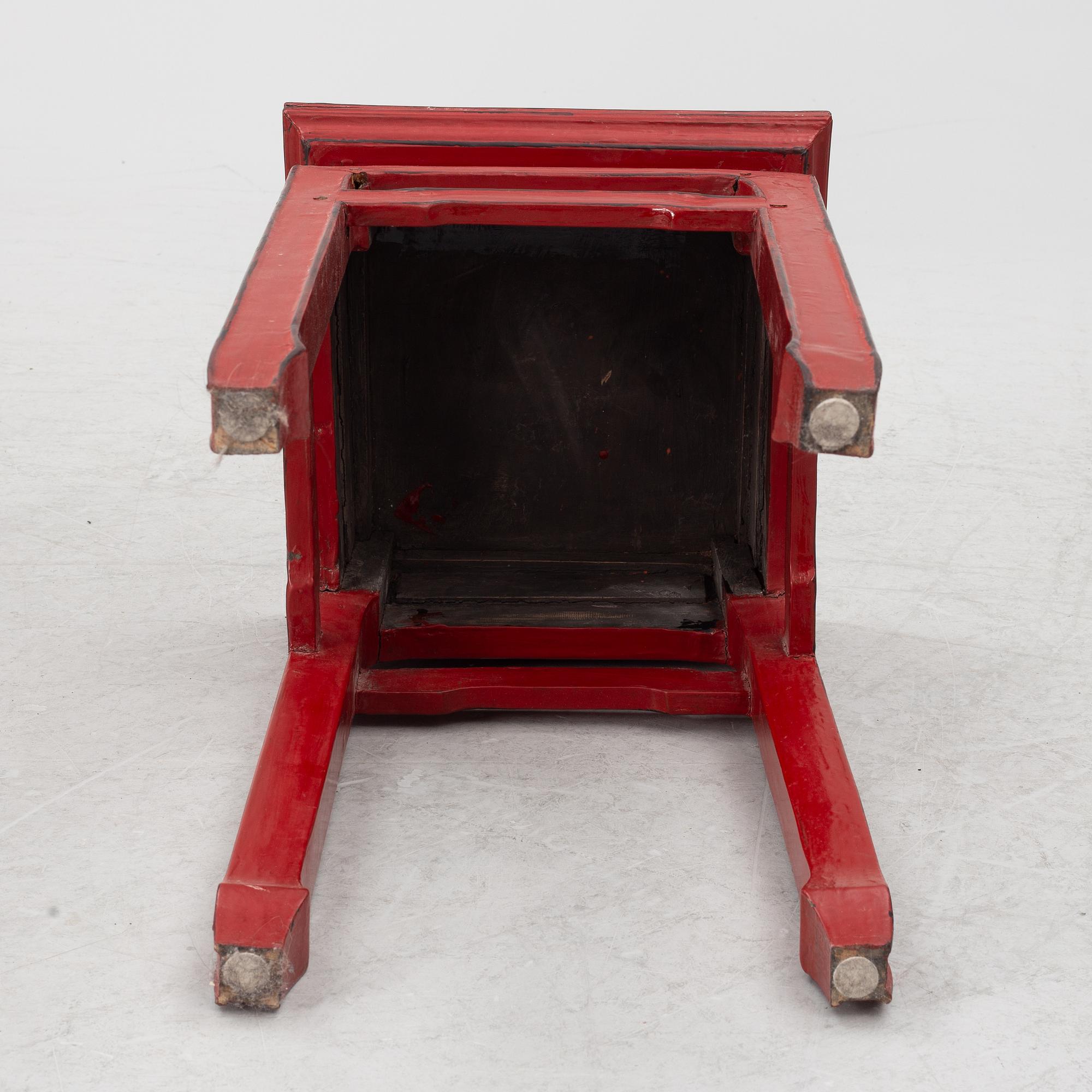 A pair of red Chinese small tables, 20th century.