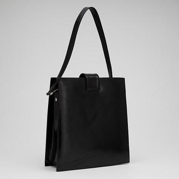 GUCCI, a black patent leather handbag.