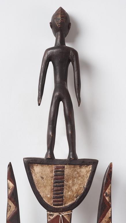 A sculptue and two masks reportedly from The Ivory coast, from the second half of the 20:th century.
