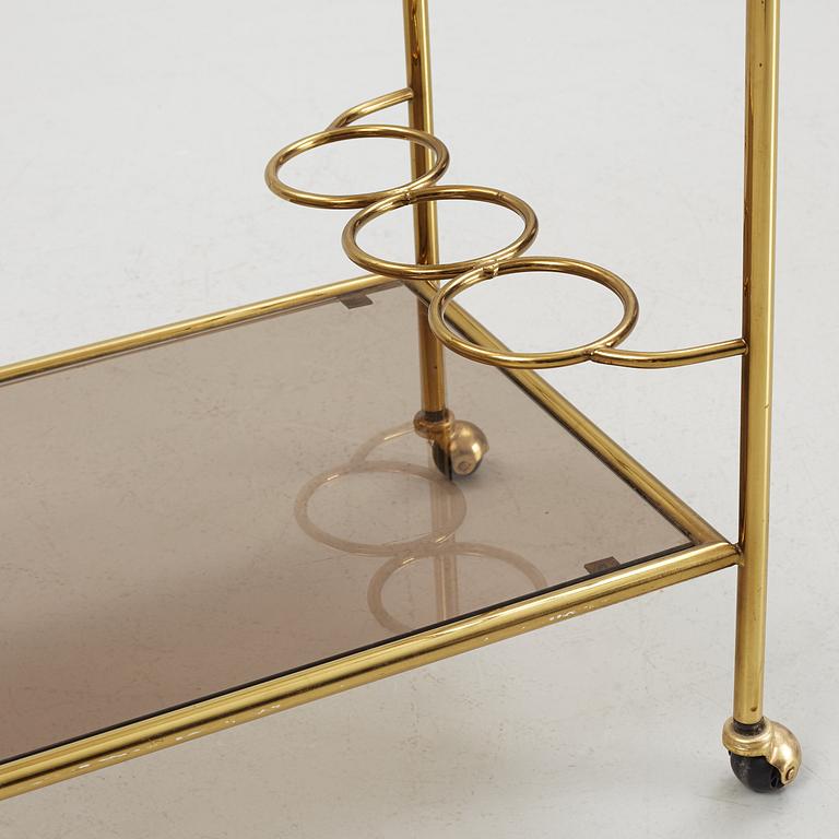 A 1970's glass and brass drinks trolley.