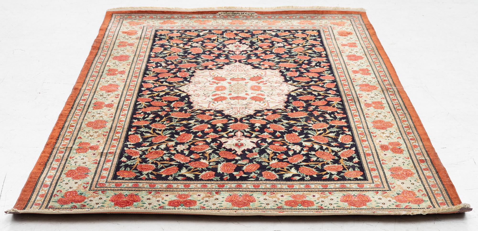 A signed silk Qum rug. c. 154 x 103 cm.
