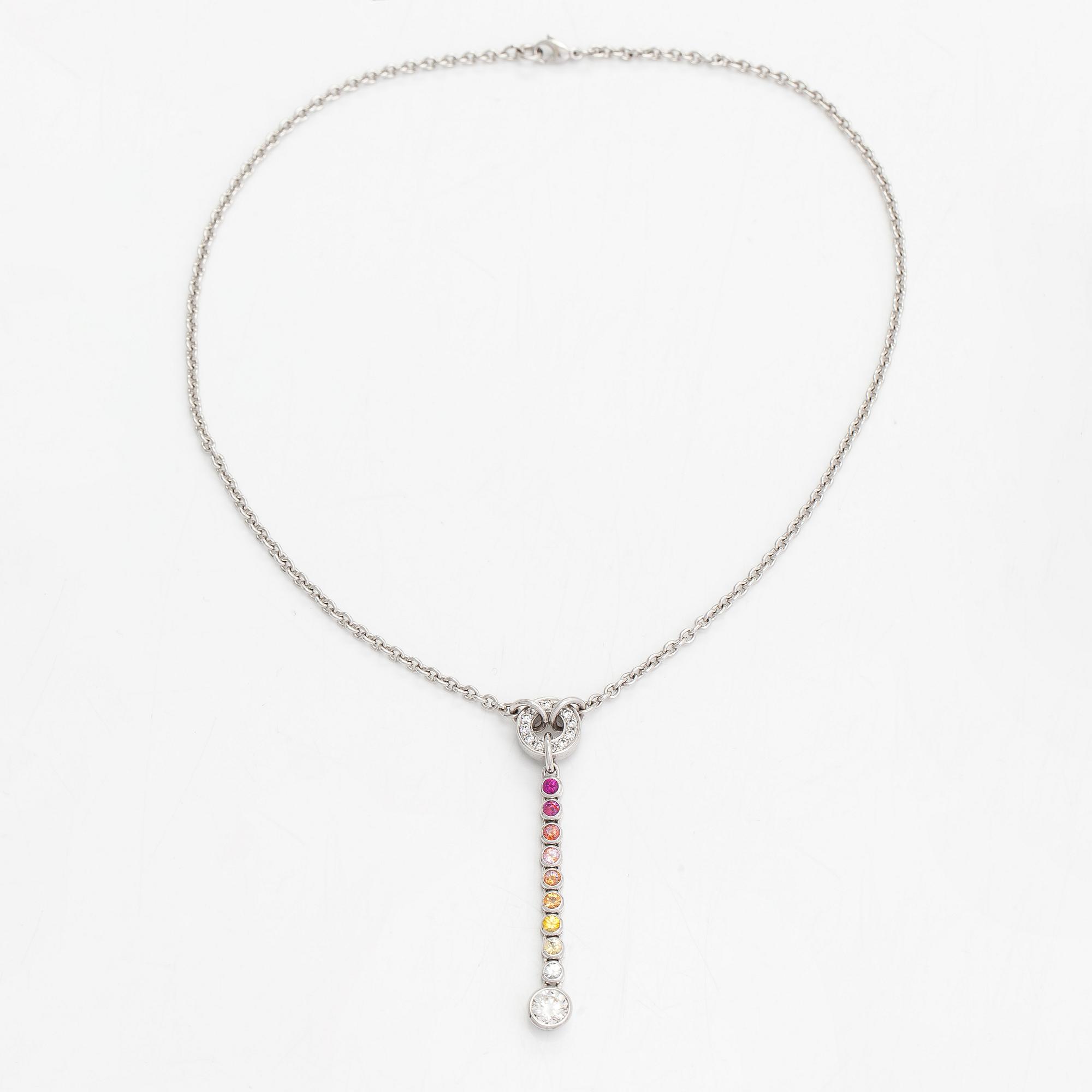 An 18K whitegold necklace with a diamond ca 1.01 ct, smaller diamonds tot. ca 0.15 ct, ruby and 
sapphires, Helsinki.