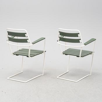 A mid  20th Century garden set with a table and four chairs.