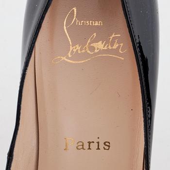 CHRISTIAN LOUBOUTIN, a pair of black patent leather pumps.