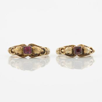 Two rings in silver with pink/red stones.