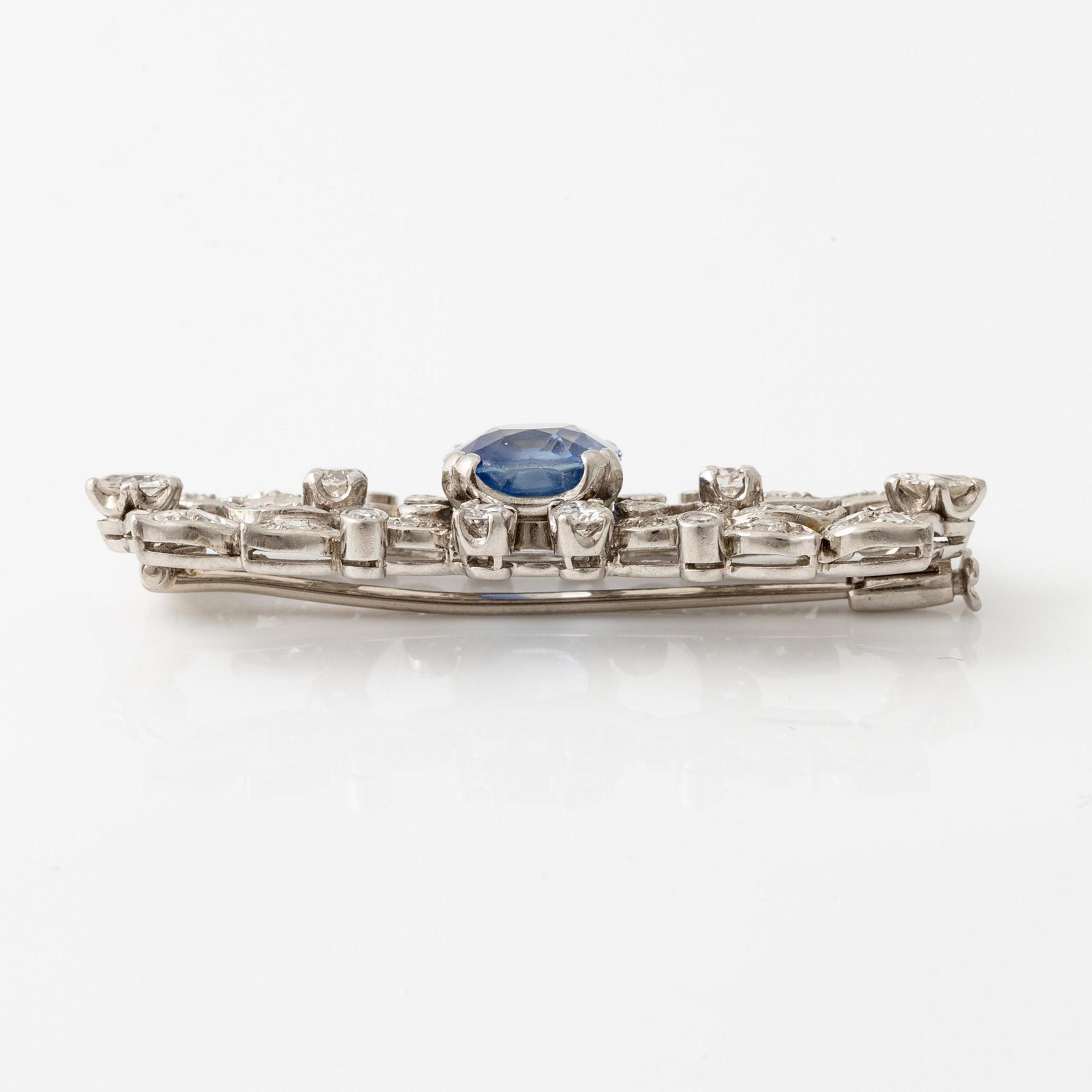 A W.A. Bolin brooch in platinum with a faceted sapphire.