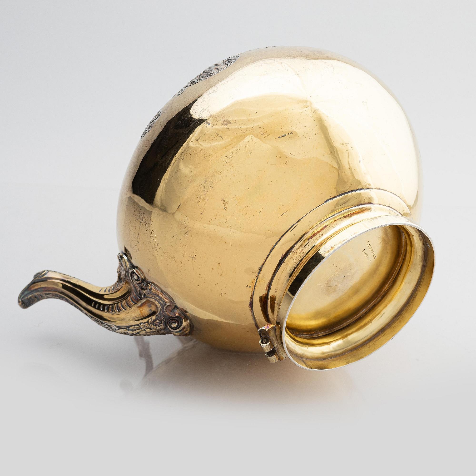 An English silver-gilt teapot with stand and burner, mark of Richard Sibley I, London 1825.