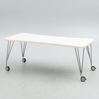 A contemporary table on wheels.