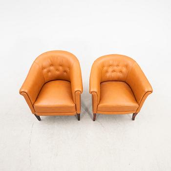 A set of two  1940s leather armchairs.