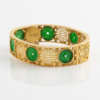 Gold bangle with green stone, possibly jadeite.