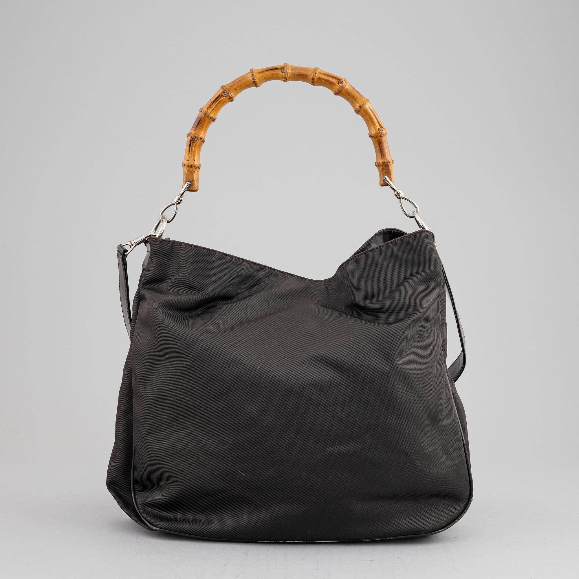 Gucci, a chocolate brown nylon handbag.