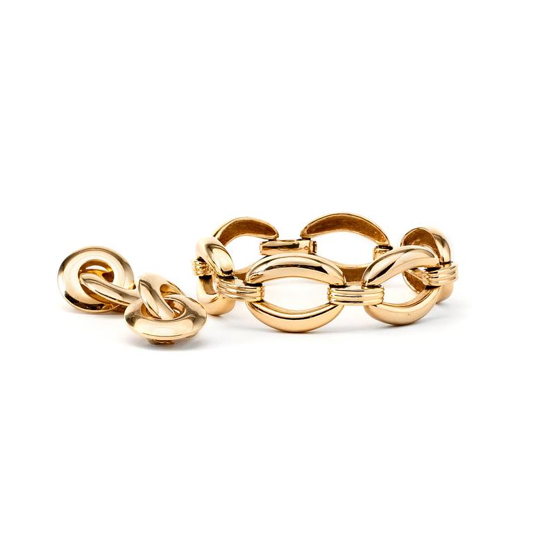 CHRISTIAN DIOR, a gold colored bracelet and clips earrings.