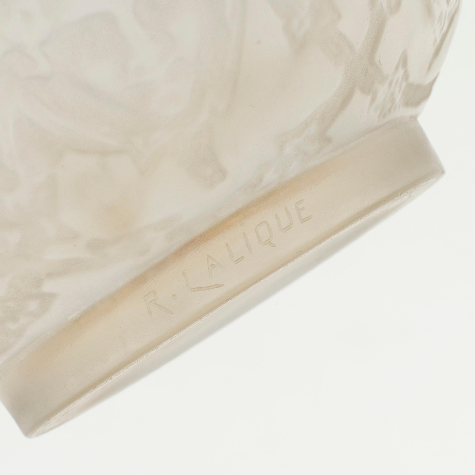 A René Lalique 'Six figurines et masques' moulded glass vase, France 1920-30's.