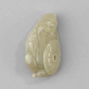 1402. A Chinese nephrite figure of a immortal holding a fish.