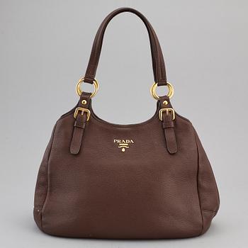 PRADA, a brown leather bag.