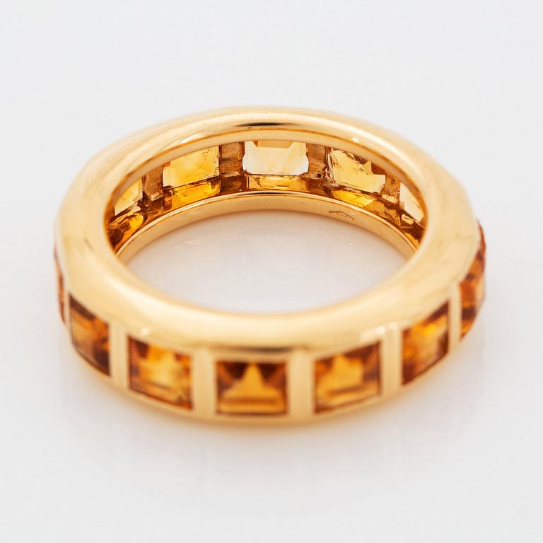 An 18K gold ring set with step-cut citrines.