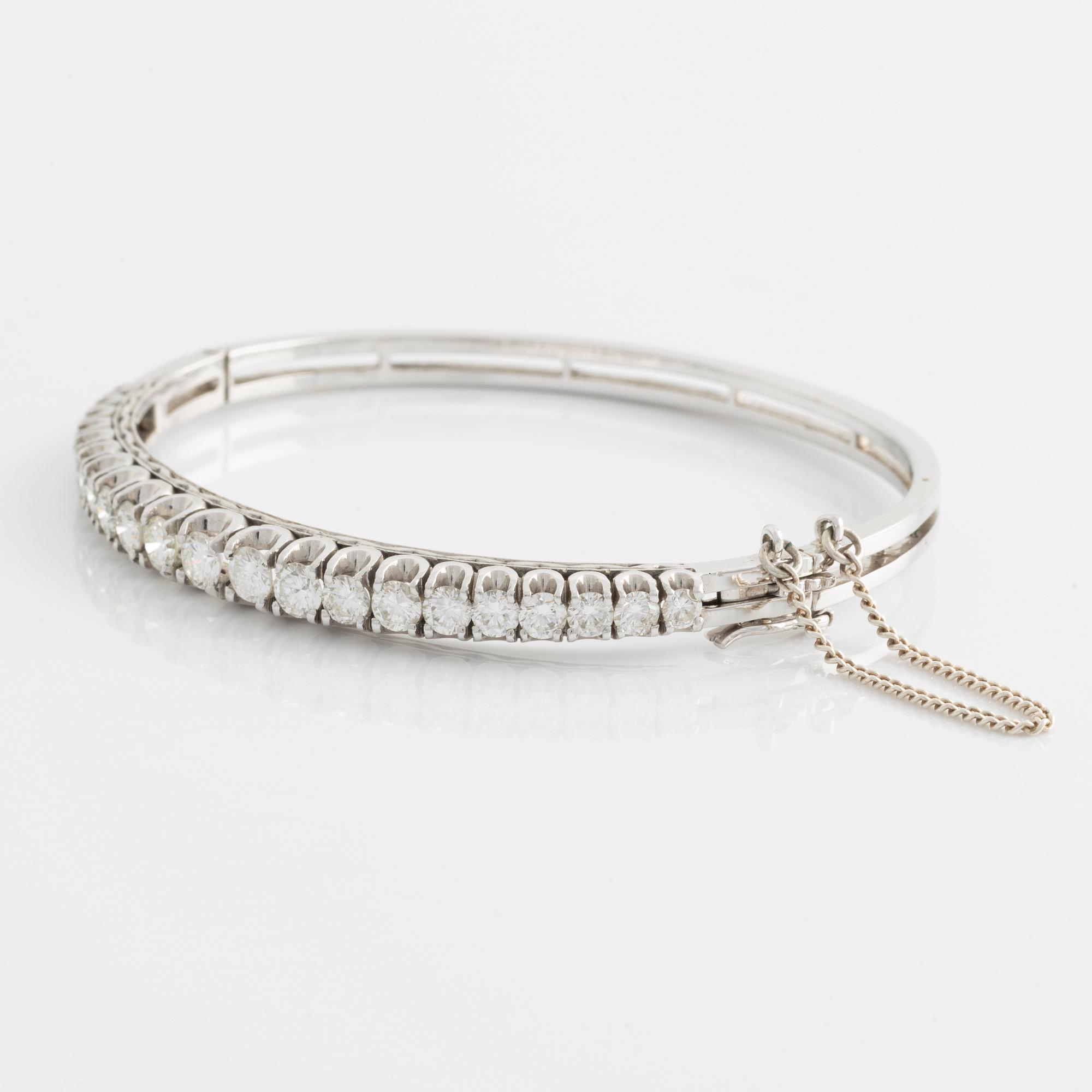 14K gold bangle with round brilliant-cut diamonds.