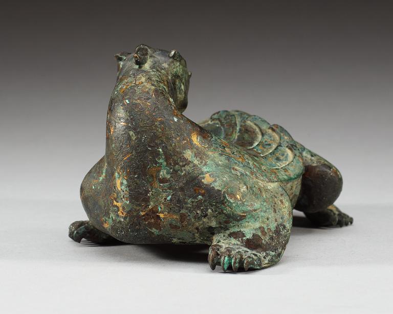 An archaistic bronze figure of a mythological beast.