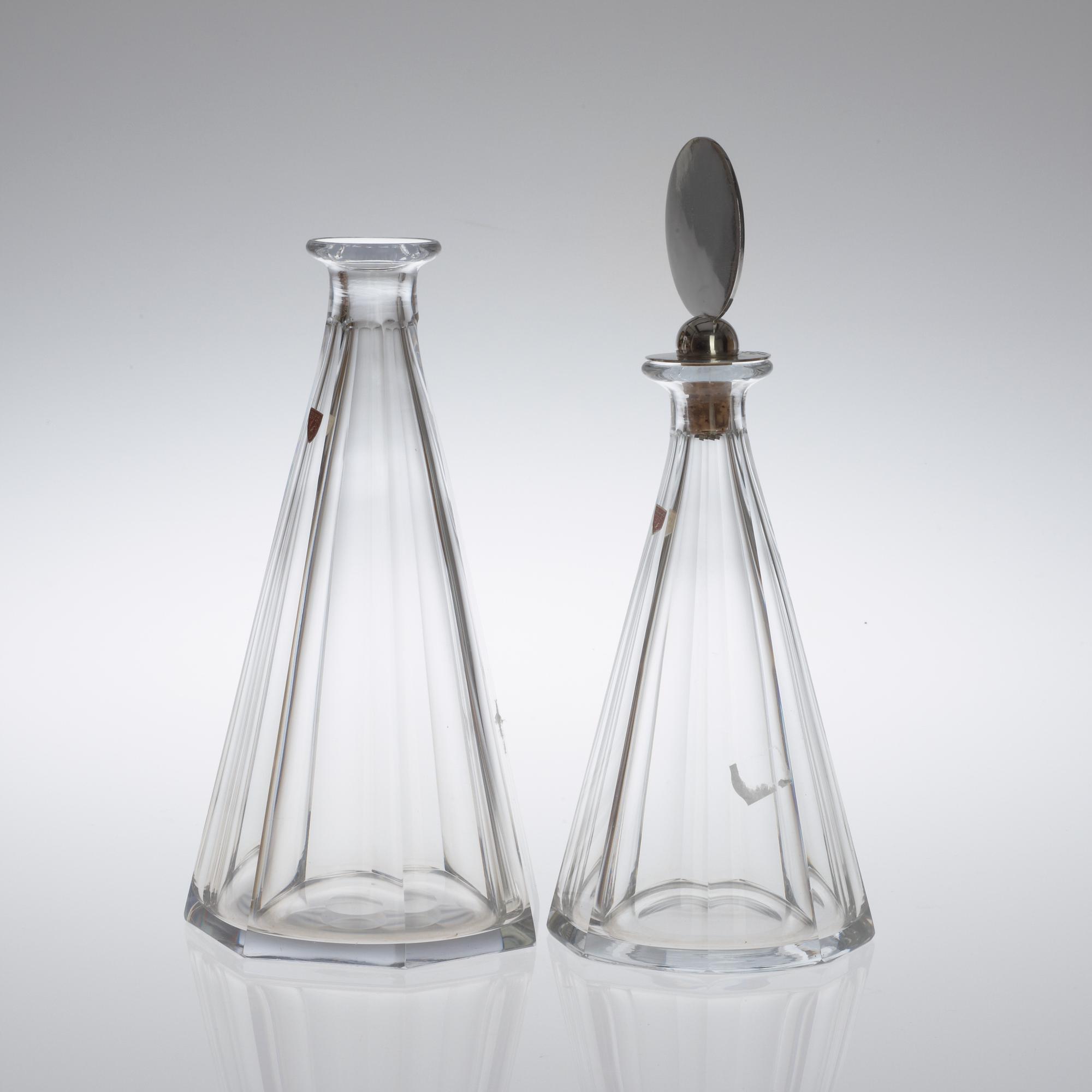 Two Wiwen Nilsson and Orrefors glass decanters, the one with a sterling stopper, Lund 1949.