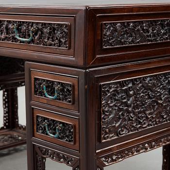 A carved hardwood desk, late Qing dynasty, circa 1900.