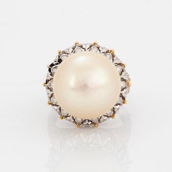 An 18K gold ring set with a cultured pearl and round brilliant-cut diamonds.