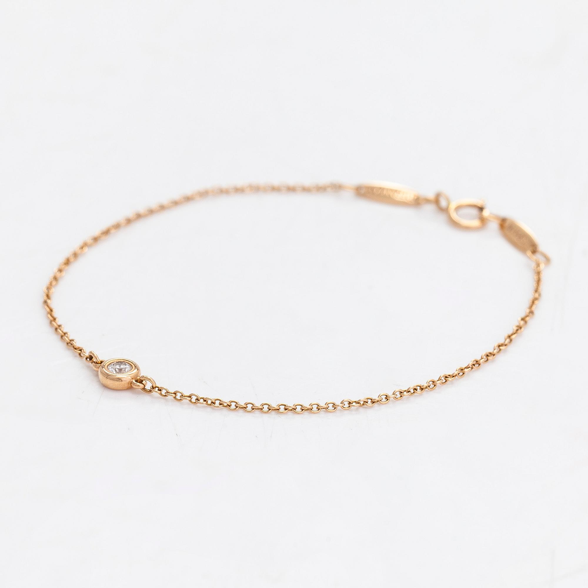 Tiffany & Co, Elsa Peretti, an 18K gold bracelet with a brilliant cut diamond ca 0.07 ct.