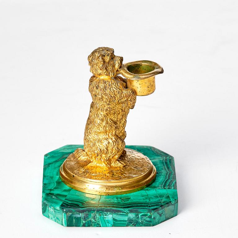 A Russian Nicholas II malachite-veneered and gilt-bronze candlestick, late 19th century.