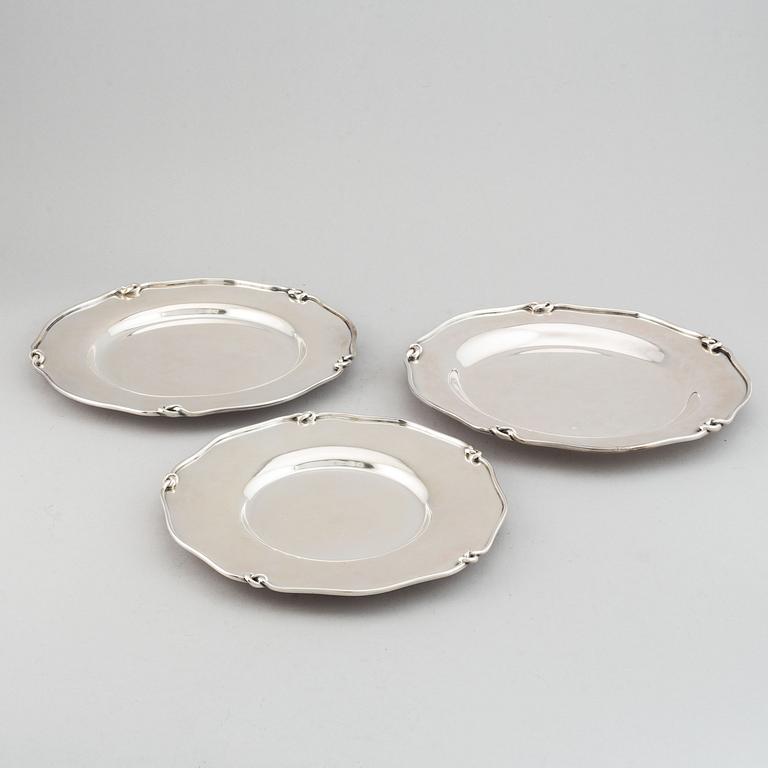Three silver serving plates, decorated with "knots", Swedish import marks.