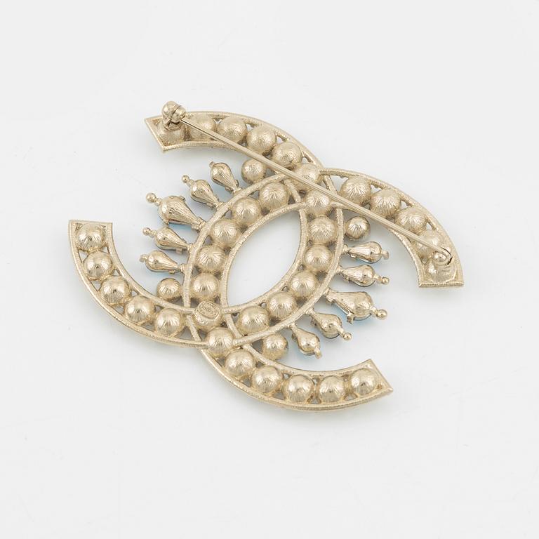 Chanel, a silvermetal, rhinestone and crystal brooch, 2019.