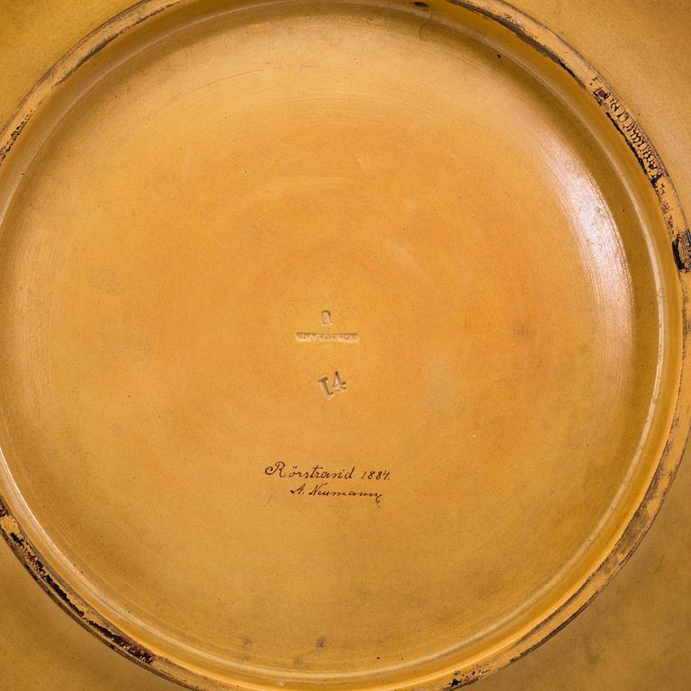 A wall plate by Adolf Neumann, Rörstrand, signed on verso 1884.