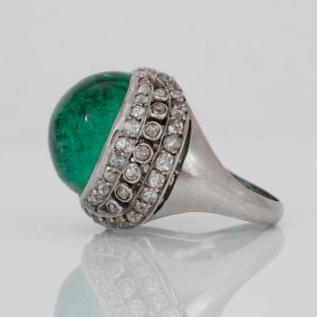 A cabochon-cut emerald and old-cut diamond ring.