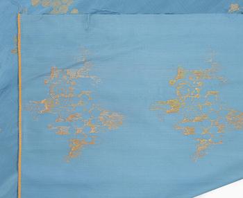 A bolt of Chinese pale blue and gold silk fabric, early 20th century.