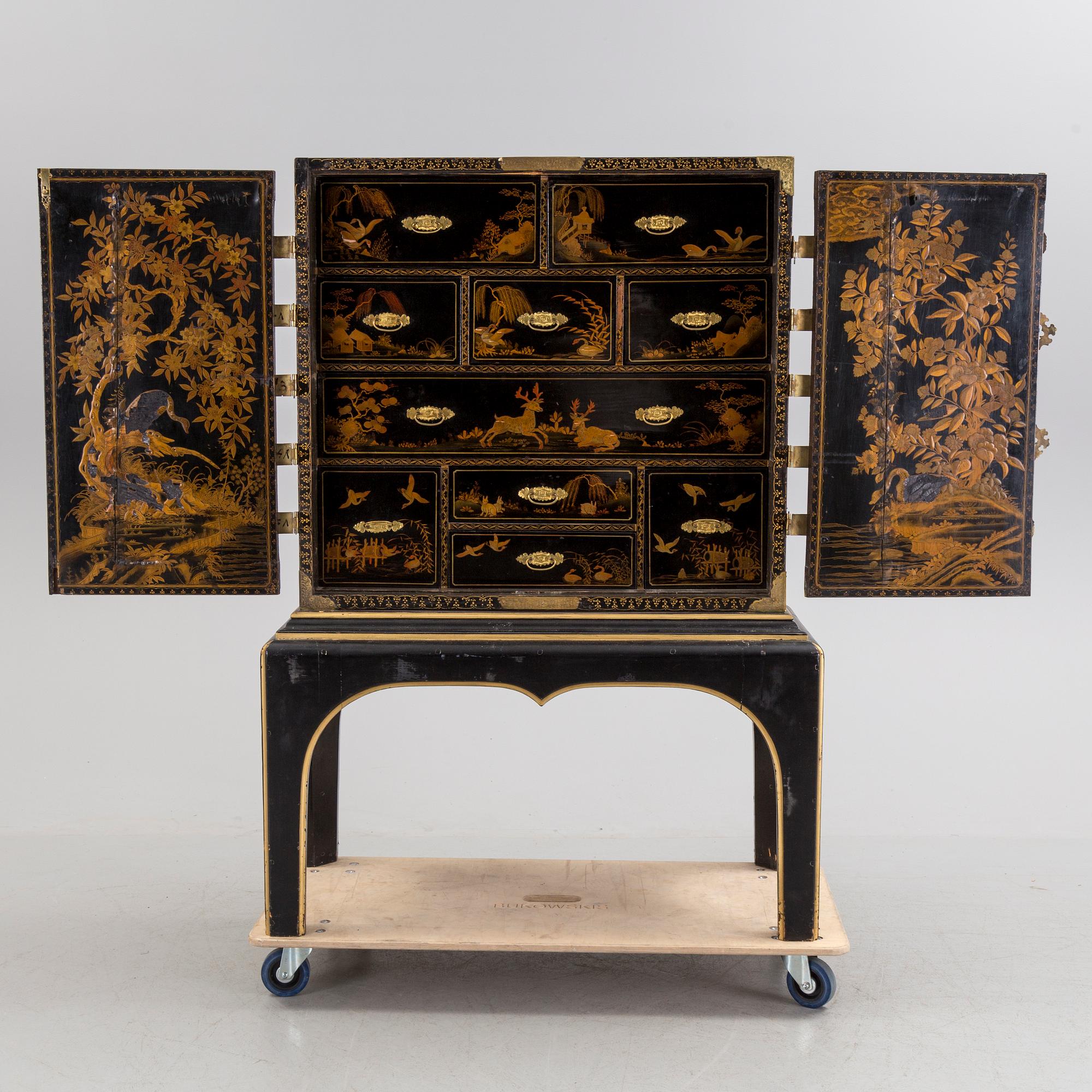 AN early 18TH CENTURY PROBABLY ENGLISH Japanned laquer cabinet on stand.