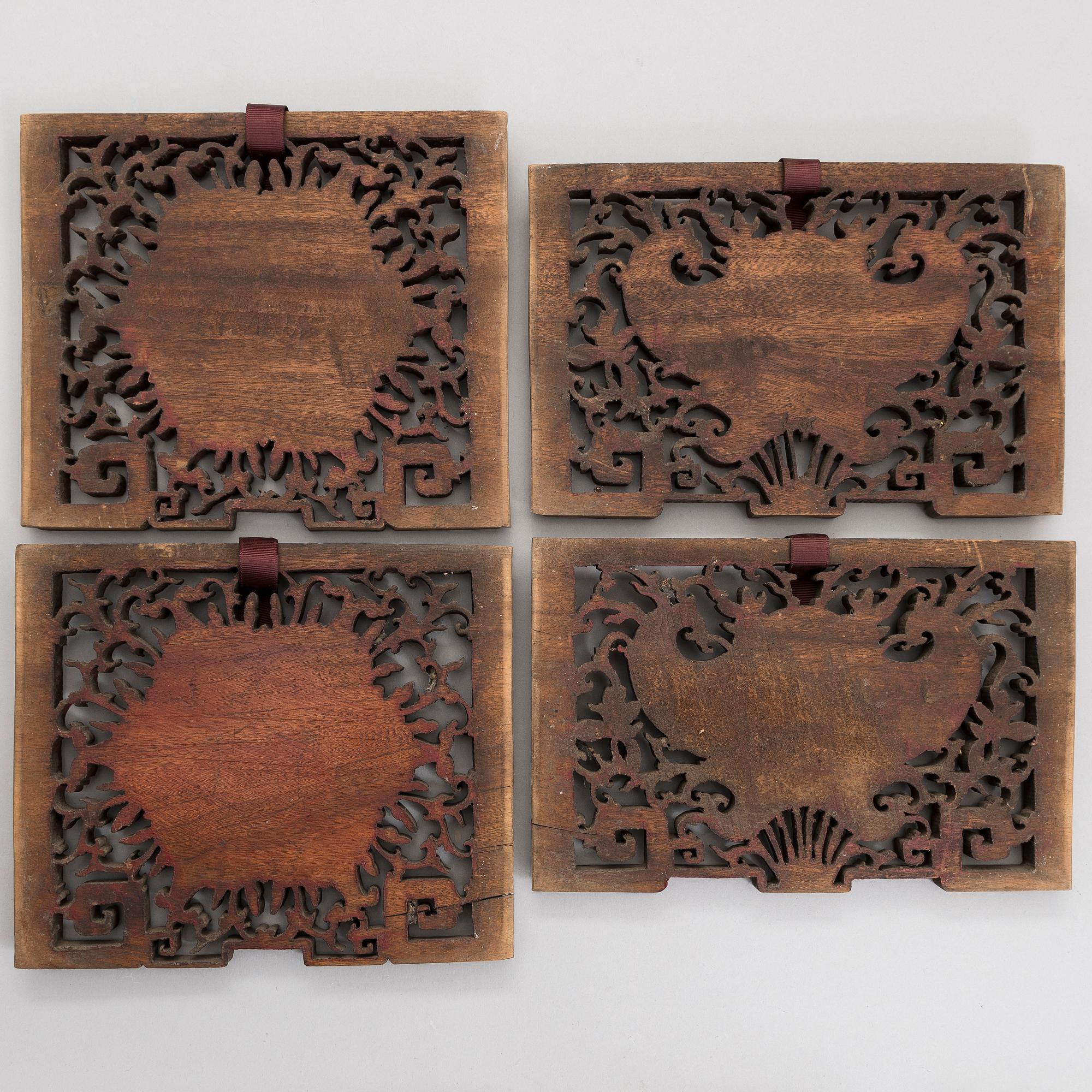 A set of four Chinese gilt and painted wooden decorations.