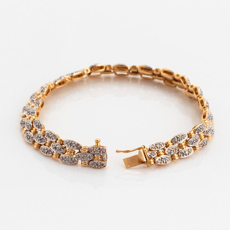 An 18K gold and white gold bracelet set with round brilliant-cut diamonds.