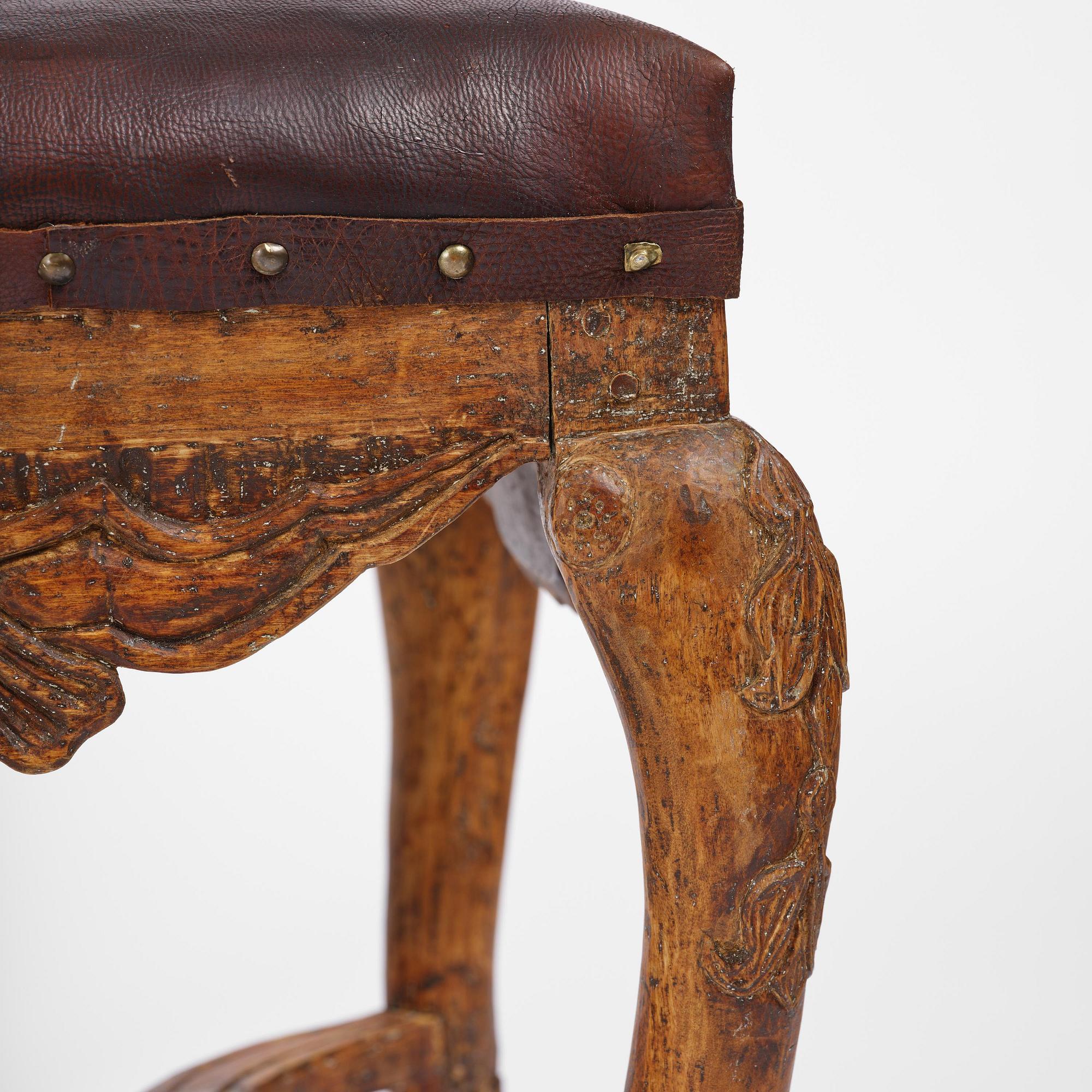A pair of carved stools in the manner of Jonas Granberg, Jämtland, Sweden, mid 18th century.