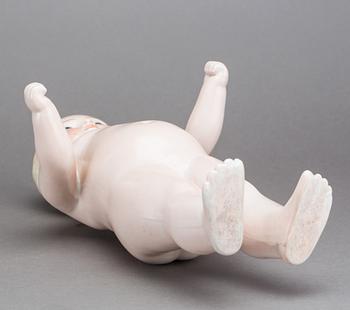 A PORCELAIN "FROZEN CHARLIE" DOLL, from around 1900.