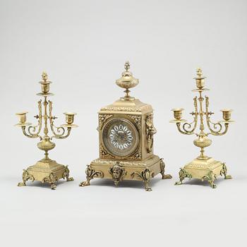 A table clock and two candelabras, around the year 1900.