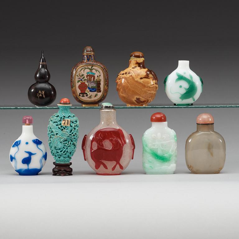 A group of nine peking glass, porcelain, stone, cloisonné and bone snuff bottles.