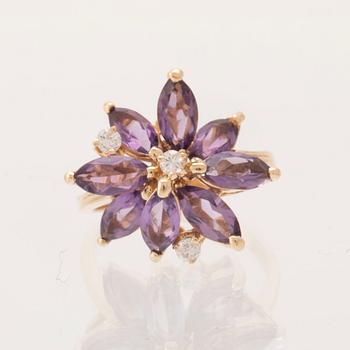 A 14K gold cocktail ring set with round brilliant-cut diamonds and navette-cut amethysts.