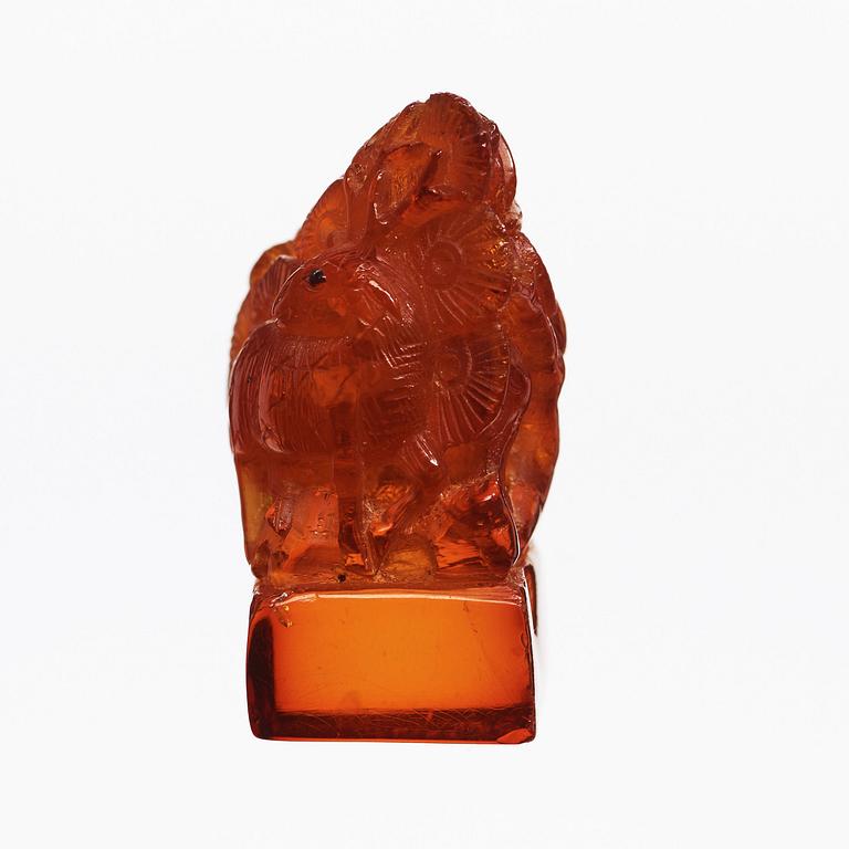 An amber sculpturein the shape of a fawn and a bird amongst pine trees, Qing dynasty (1644-1912).
