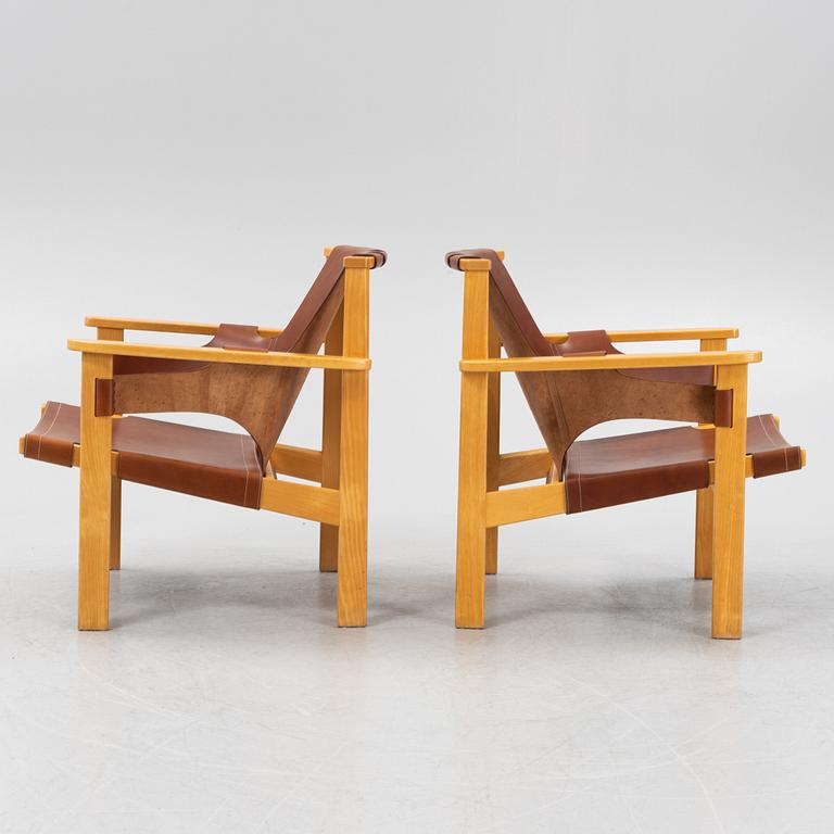 Carl-Axel Acking, a pair of oak and brown natural leather 'Trienna' chair, Nordiska Kompaniet, Sweden.