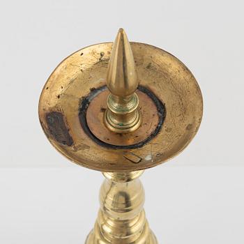 A pair of brass candle sticks, around 1700.