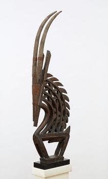 HEADDRESS. Tshiwara/Ciwara (stylized male antelope). Wooden sculpture with metal fittings.