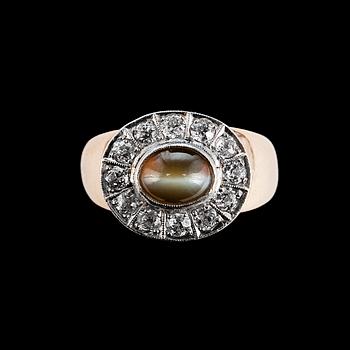 RING, 14K guld, 12 antikslipade diamanter ca 0.60 ct, krysoberyll kattöga 6 x 8 mm. Finland 1960-tal. Vikt 10g.